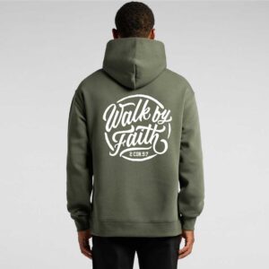 person standing in snow with their back facing forward wearing a black Christian Clothing hoodie with big printing on the back reading Walk by Faith in white inspired by the scripture 2 Corinthians 5:7